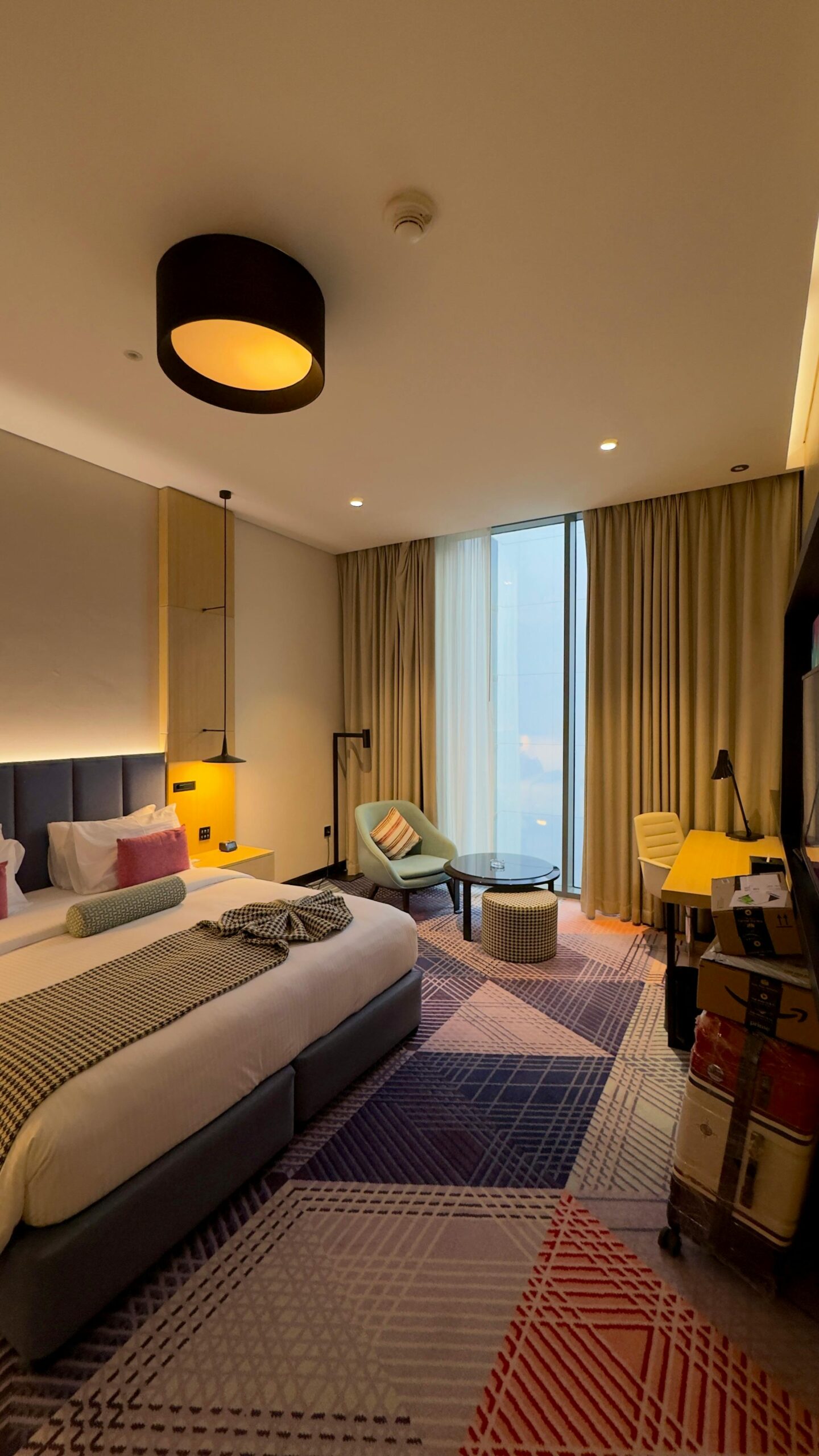 Elegant and spacious hotel room in Dubai with modern decor and designer furniture.